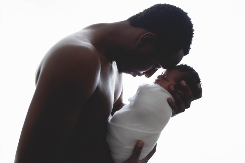 Newborn Photography, father holding baby to his forehead