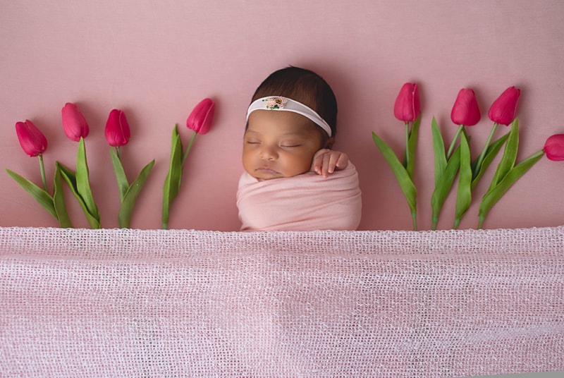 Newborn Photography, baby wrapped in pink with tulips