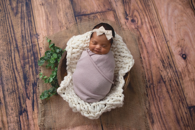 Newborn Photography, baby wrapped in a tan wrapped and bow