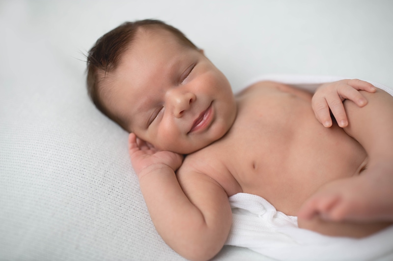 Newborn Photography, baby laying on white blanket