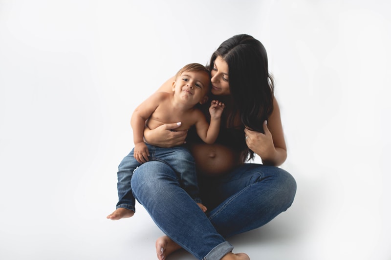 Maternity Photography, mother and son sitting on a white background
