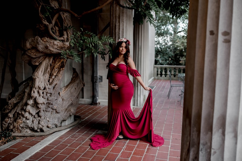Maternity Photography, woman holding out her red dress