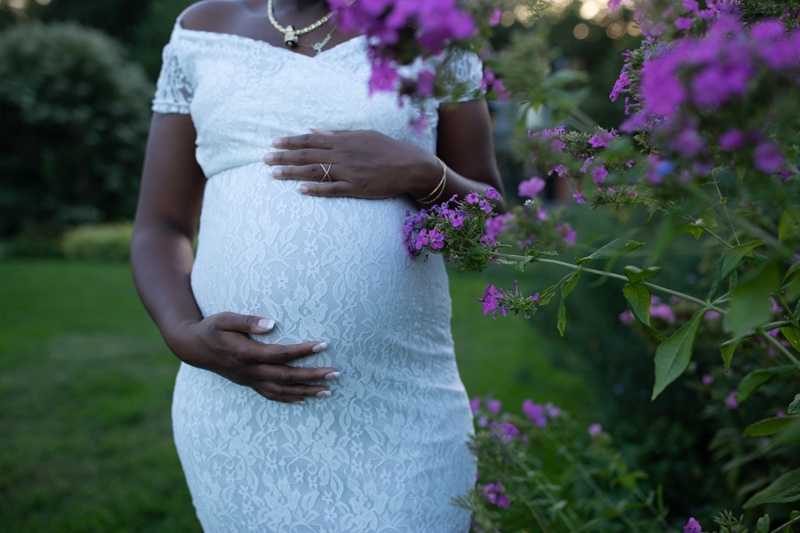 Maternity Photography, woman in white next to flowers