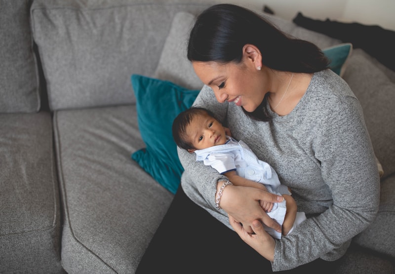 Newborn Photography, mother and baby sitting on couch together