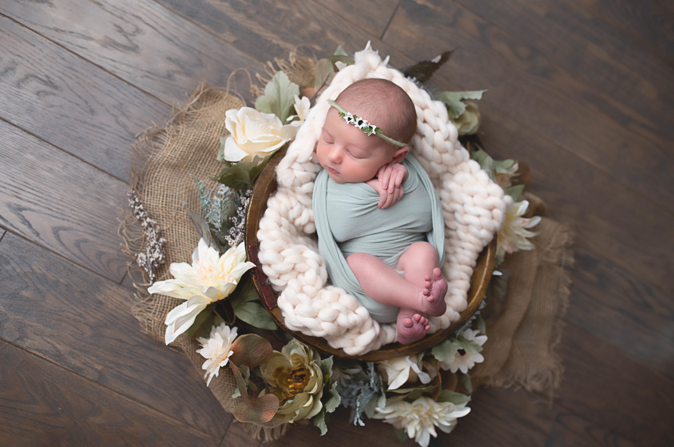 Newborn Photography, baby swaddled up in basket with flowers and a blanket